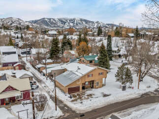 This charming property offers a cozy retreat in a picturesque winter setting.