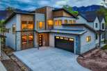 This stunning modern home boasts a striking exterior with a combination of wood and stone accents.