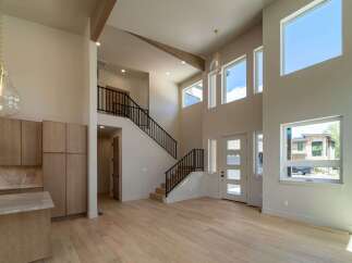 This stunning property boasts a modern interior with soaring ceilings and an open floor plan, perfect for entertaining.