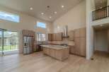 This stunning kitchen boasts a modern design with high ceilings and ample natural light.