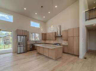 This stunning kitchen boasts a modern design with high ceilings and ample natural light.
