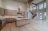 This stunning kitchen boasts a modern design with sleek cabinetry and a spacious island, perfect for both cooking and entertaining.