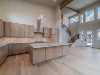 This stunning kitchen boasts a modern design with sleek cabinetry and a spacious island, perfect for both cooking and entertaining.