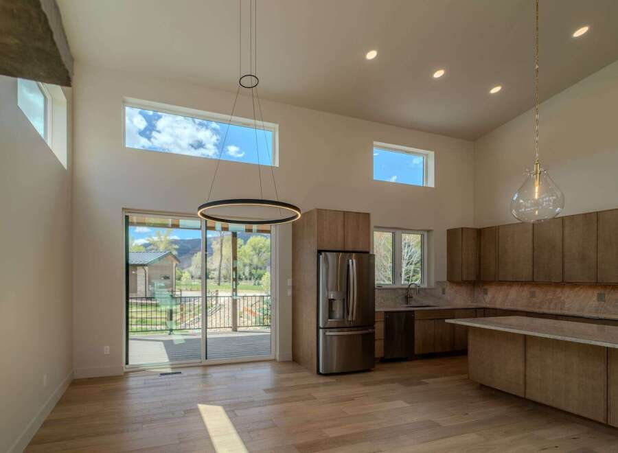 This stunning modern kitchen boasts high ceilings and an open floor plan, perfect for entertaining.