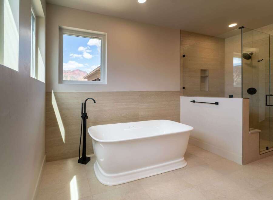 Indulge in luxury within this stunning bathroom, featuring a freestanding tub and a separate glass-enclosed shower.