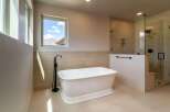 Indulge in luxury within this stunning bathroom, featuring a freestanding tub and a separate glass-enclosed shower.