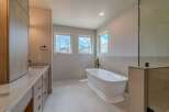 This luxurious bathroom boasts a modern design with a freestanding bathtub, perfect for relaxation.