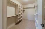 Step into luxury with this meticulously designed walk-in closet.