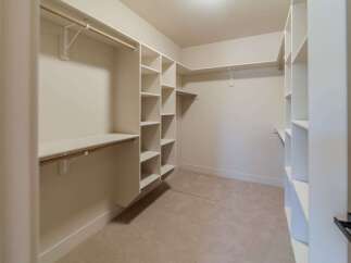 Step into luxury with this meticulously designed walk-in closet.