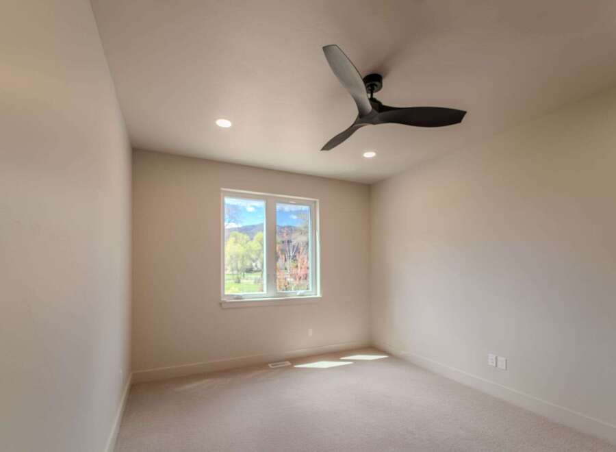 Step into this bright and airy room, featuring a modern ceiling fan and recessed lighting.