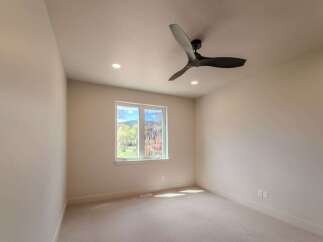 Step into this bright and airy room, featuring a modern ceiling fan and recessed lighting.