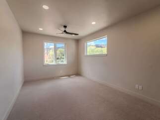 This spacious room offers a bright and airy atmosphere, perfect for relaxation or productivity.