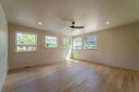 This spacious room features beautiful hardwood floors and ample natural light streaming in from the large windows.