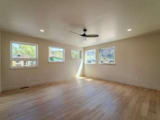 This spacious room features beautiful hardwood floors and ample natural light streaming in from the large windows.