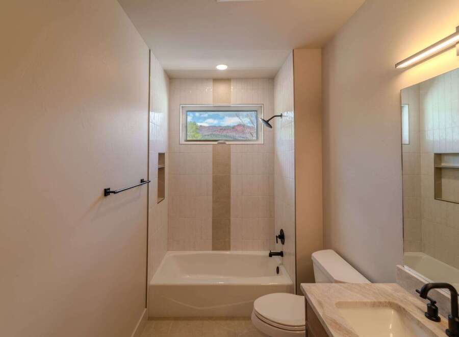 This stunning bathroom features a modern design with a beautiful view.