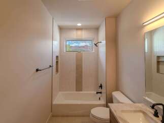 This stunning bathroom features a modern design with a beautiful view.