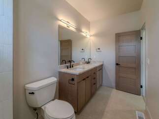 This stunning bathroom boasts a modern design with a double vanity and sleek fixtures.