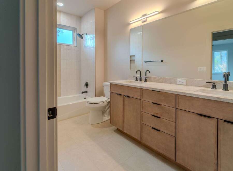 Step into luxury with this stunning bathroom! Featuring a modern vanity with ample storage, a sleek mirror, and a bright, inviting atmosphere.