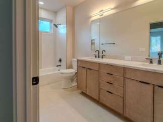 Step into luxury with this stunning bathroom! Featuring a modern vanity with ample storage, a sleek mirror, and a bright, inviting atmosphere.