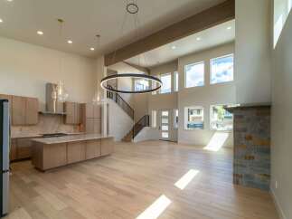 This stunning modern home boasts an open-concept design with soaring ceilings and abundant natural light.