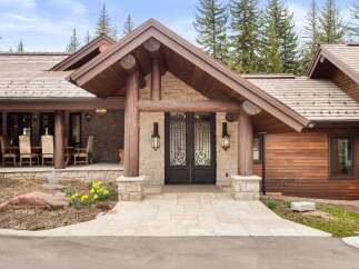 This stunning property boasts a rustic yet elegant design, featuring a beautiful stone facade and a welcoming entrance.