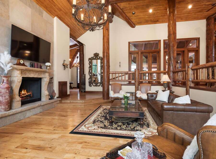 Step into luxury with this stunning property featuring a grand fireplace and a cozy living area.