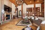 Step into luxury with this stunning property featuring a grand fireplace and a cozy living area.