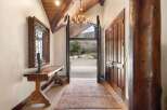 Step into luxury with this stunning entryway, showcasing a blend of rustic charm and elegant design.