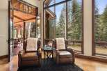 Experience the epitome of luxury living in this stunning property, featuring a serene interior with two elegant leather armchairs.