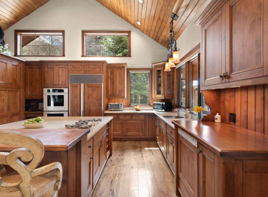 This stunning kitchen boasts custom cabinetry, offering ample storage and a warm, inviting atmosphere.