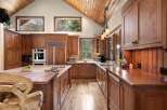 This stunning kitchen boasts custom cabinetry, offering ample storage and a warm, inviting atmosphere.