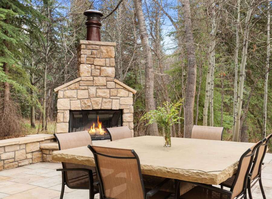 Enjoy the warmth of a cozy outdoor fireplace in this stunning property.