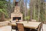 Enjoy the warmth of a cozy outdoor fireplace in this stunning property.