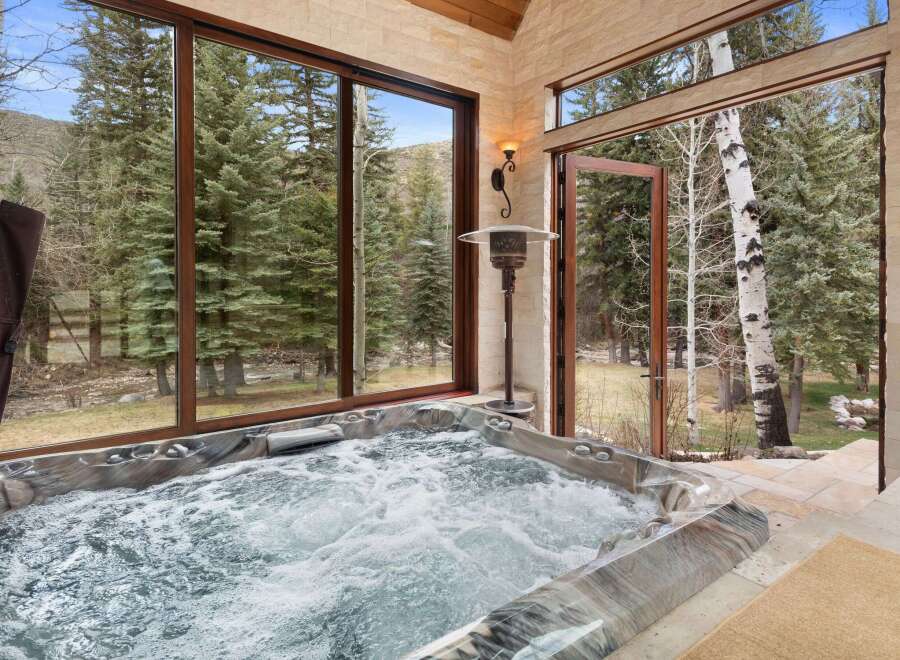 Indulge in luxury with this stunning property featuring a private hot tub, perfect for relaxation and rejuvenation.