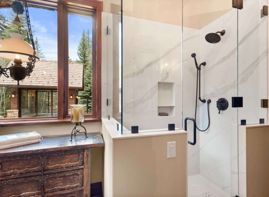Step into luxury with this stunning bathroom featuring a modern glass shower enclosure.