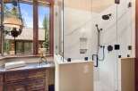 Step into luxury with this stunning bathroom featuring a modern glass shower enclosure.