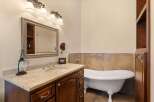 Step into luxury with this stunning bathroom featuring a clawfoot tub and elegant vanity.