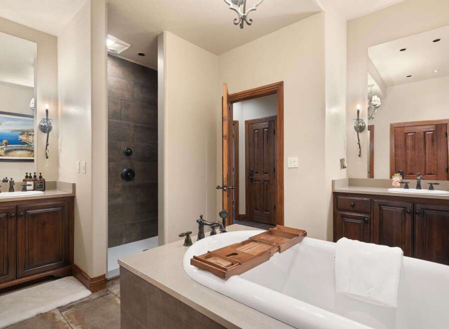 Indulge in luxury within this stunning bathroom, featuring a spacious soaking tub perfect for relaxation.