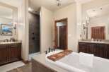 Indulge in luxury within this stunning bathroom, featuring a spacious soaking tub perfect for relaxation.