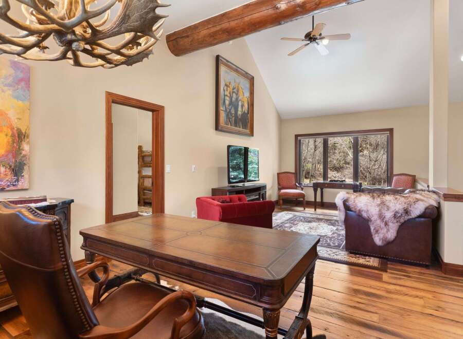 Step into luxury with this stunning property, featuring a spacious living area with a cozy fireplace and elegant hardwood floors.