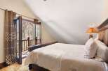 Experience the tranquility of this stunning bedroom, featuring a cozy bed and a private balcony.