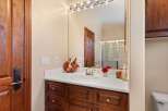 This stunning bathroom boasts a beautiful vanity with rich, dark wood cabinetry, offering ample storage and a touch of elegance.