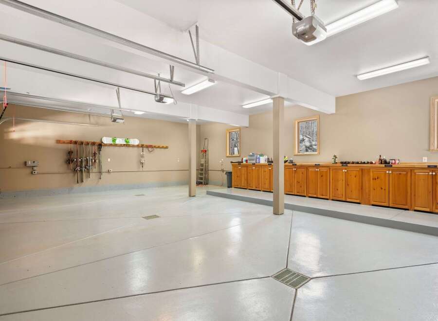 This spacious garage offers ample room for vehicles and storage, featuring a sleek, polished floor.