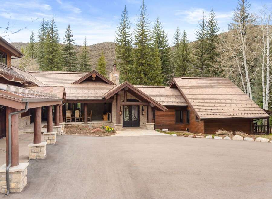 This stunning mountain home boasts a beautiful exterior with a blend of natural materials.