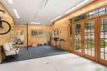 This stunning home gym offers a perfect blend of functionality and style, ideal for fitness enthusiasts.