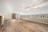 Step into this stunning, light-filled space featuring a vaulted ceiling and beautiful wood flooring.