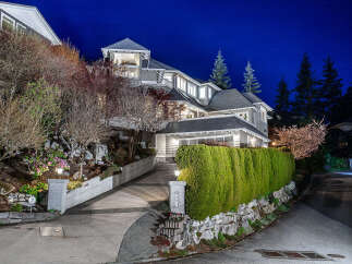 This stunning property boasts a beautifully designed exterior with a well-manicured lawn and lush landscaping.