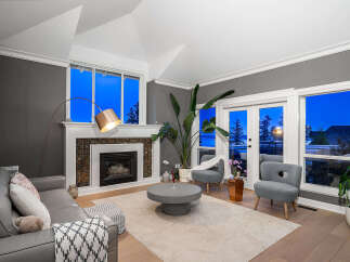 Step into luxury with this stunning living room, boasting a cozy fireplace and elegant design.