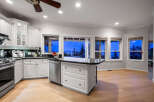 This stunning kitchen boasts a modern design with sleek white cabinetry and a contrasting black countertop.