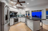 This stunning kitchen boasts a modern design with sleek white cabinetry and stainless steel appliances.